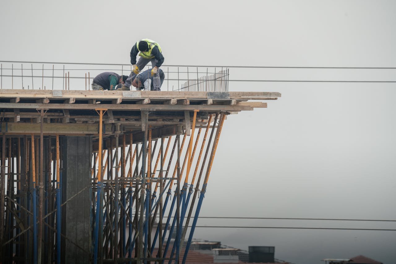 Workers on a high-rise building construction site in Denizli, Türkiye, showcasing teamwork and safety.